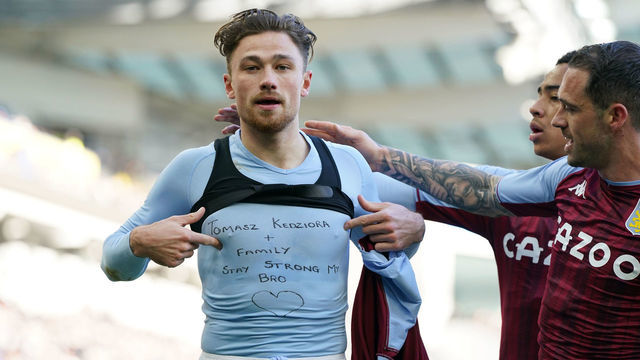 Aston Villa's Matty Cash celebrates scoring their side's first goal of the game, and reveals a t-shirt supporting Poland team-mate Tomasz Kedziora during the Premier League match at the AMEX Stadium, Brighton. Picture date: Saturday February 26, 2022.