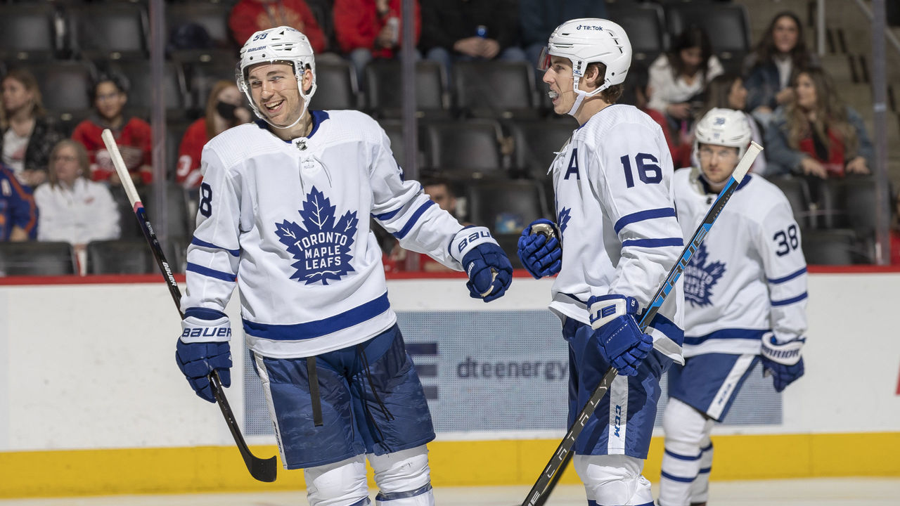 DETROIT, MI - FEBRUARY 26: Michael Bunting #58 of the Toronto Maple Leafs congratulates teammate Mitchell Marner #16 after he scores a goal during the second period of an NHL game against the Detroit Red Wings at Little Caesars Arena on February 26, 2022 in Detroit, Michigan.