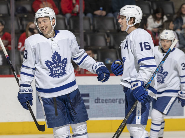 DETROIT, MI - FEBRUARY 26: Michael Bunting #58 of the Toronto Maple Leafs congratulates teammate Mitchell Marner #16 after he scores a goal during the second period of an NHL game against the Detroit Red Wings at Little Caesars Arena on February 26, 2022 in Detroit, Michigan.