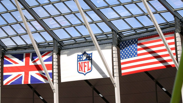LONDON, ENG - OCTOBER 13: The British flag and the United States flags hang from the stadium roof along side the NFL logo during the game between the Carolina Panthers and the Tampa Bay Buccaneers on October 13th, 2019 at Tottenham Hotspur Stadium in London, England.