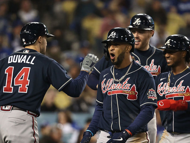 LOS ANGELES, CALIFORNIA - OCTOBER 20: Eddie Rosario #8 of the Atlanta Braves celebrates a three run home run during the ninth inning of Game Four of the National League Championship Series against the Los Angeles Dodgers at Dodger Stadium on October 20, 2021 in Los Angeles, California.