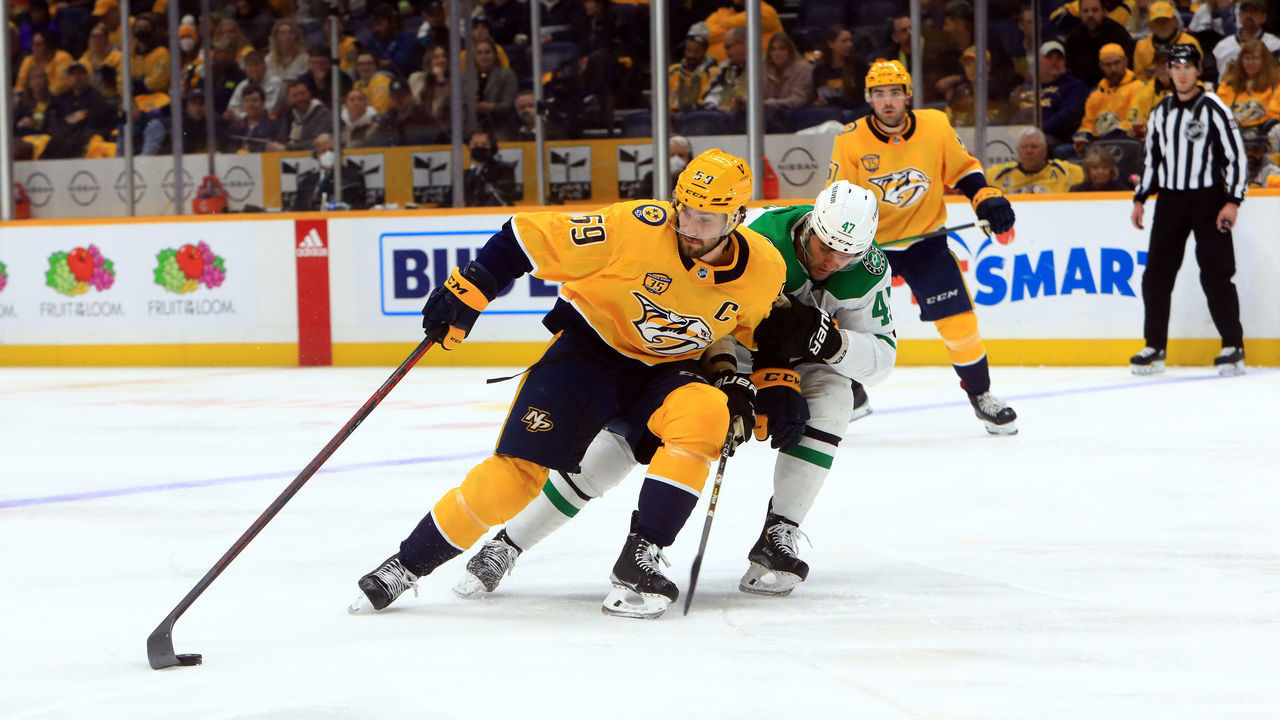 NASHVILLE, TN - FEBRUARY 24: Dallas Stars right wing Alexander Radulov (47) defends against Nashville Predators defenseman Roman Josi (59), of Switzerland, during the NHL game between the Nashville Predators and Dallas Stars, held on February 24, 2022, at Bridgestone Arena in Nashville, Tennessee.
