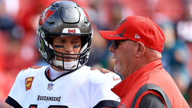 TAMPA, FLORIDA - JANUARY 16: Tom Brady #12 of the Tampa Bay Buccaneers talks with head coach Bruce Arians prior to the NFC Wild Card Playoff game against the Philadelphia Eagles at Raymond James Stadium on January 16, 2022 in Tampa, Florida.