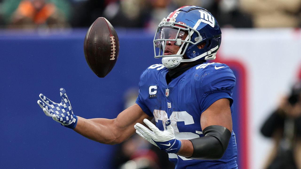 EAST RUTHERFORD, NEW JERSEY - JANUARY 09: Saquon Barkley #26 of the New York Giants loses control of the ball in the third quarter of the game against the Washington Football Team at MetLife Stadium on January 09, 2022 in East Rutherford, New Jersey.