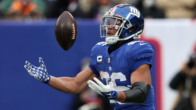 EAST RUTHERFORD, NEW JERSEY - JANUARY 09: Saquon Barkley #26 of the New York Giants loses control of the ball in the third quarter of the game against the Washington Football Team at MetLife Stadium on January 09, 2022 in East Rutherford, New Jersey.