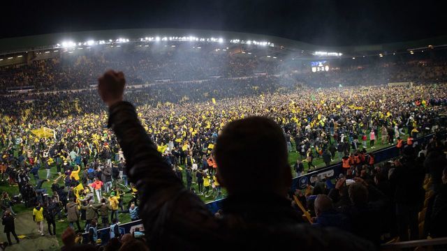 Nantes fans celebrate on the pitch after Nantes won their French Cup semi-final football match against AS Monaco at the La Beaujoire Stadium in Nantes, western France, on March 2, 2022.