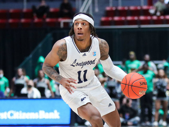 CHARLOTTE, NC - MARCH 05: Justin Hill (11) of the Longwood Lancers brings the ball down the court during the Big South Tournament between the Longwood Lancers and the USC Upstate Spartans on March 5, 2022, at Bojangles Coliseum in Charlotte, NC.