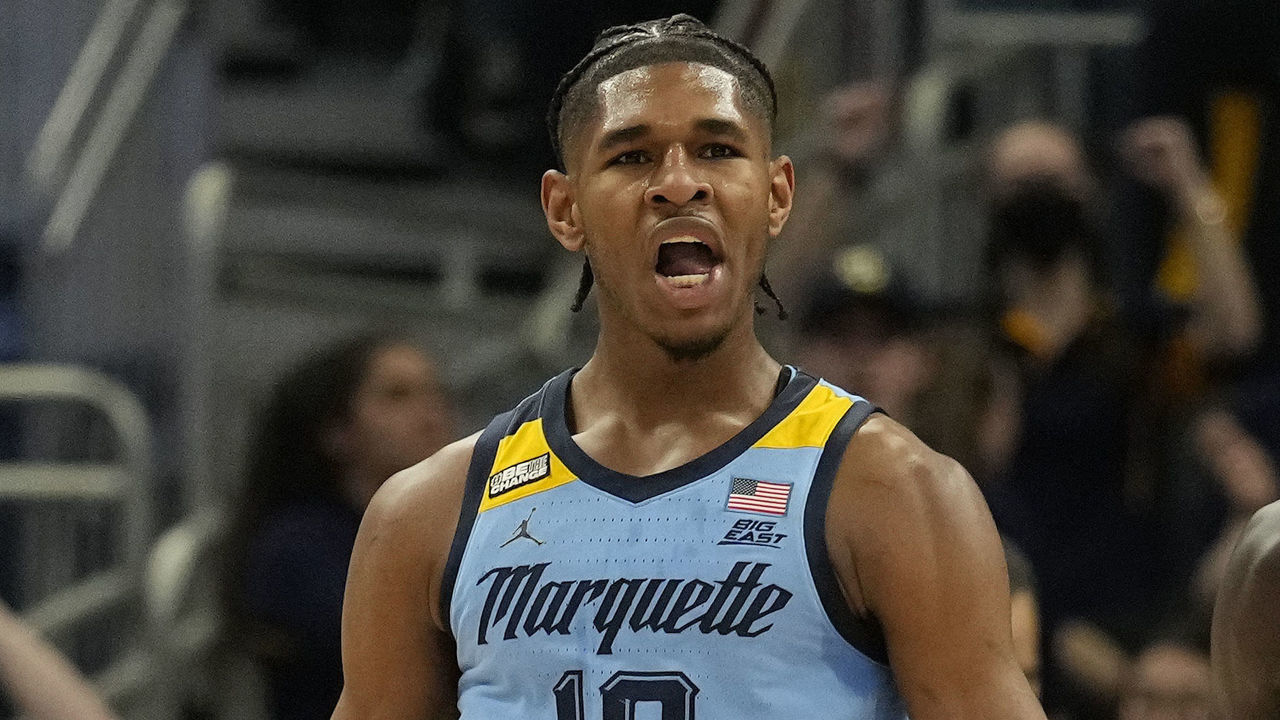 MILWAUKEE, WISCONSIN - MARCH 05: Justin Lewis #10 of the Marquette Golden Eagles celebrates after making a basket against the St. John's Red Storm during the first half at Fiserv Forum on March 05, 2022 in Milwaukee, Wisconsin.