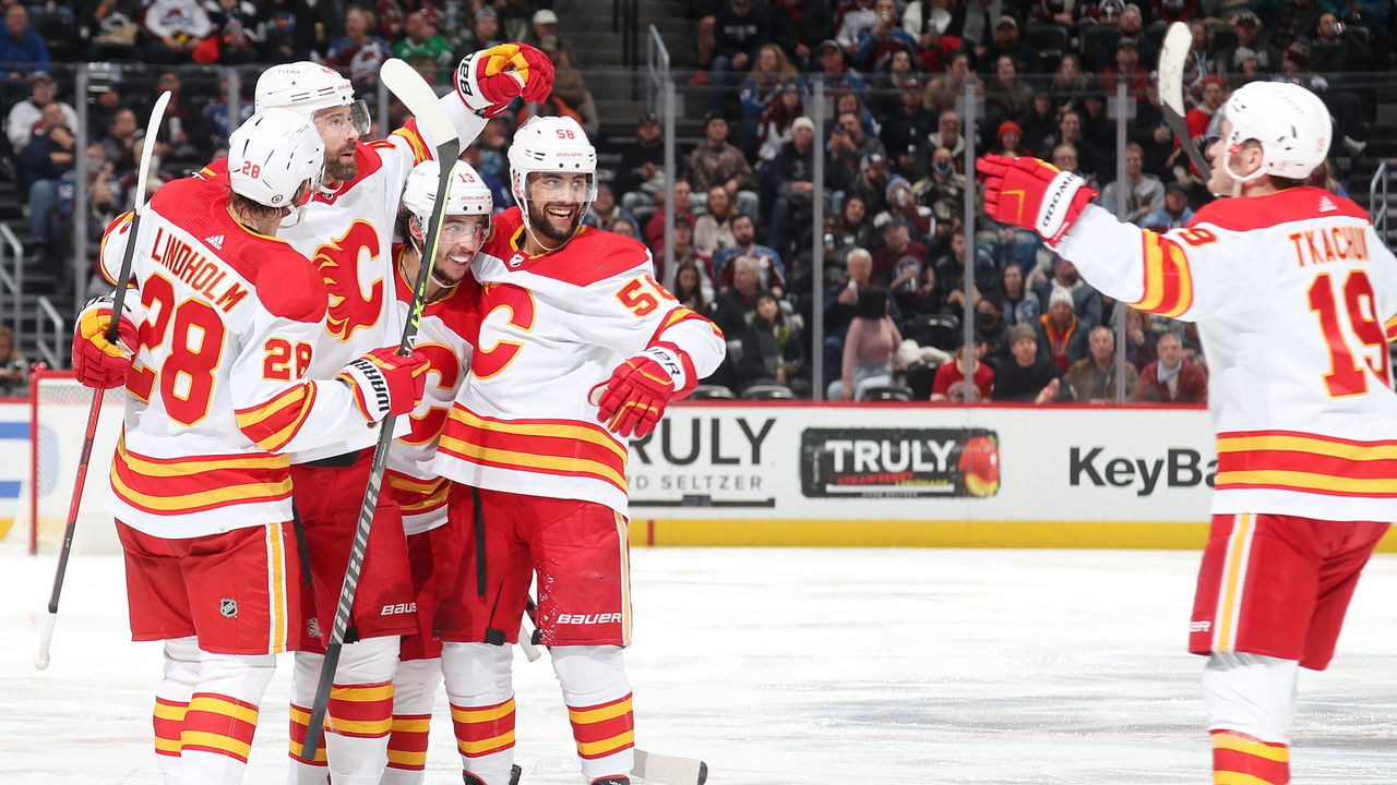 DENVER, COLORADO - MARCH 05: Erik Gudbranson #44 of the Calgary Flames celebrates a goal against the Colorado Avalanche with teammates Matthew Tkachuk #19, Elias Lindholm #28, Johnny Gaudreau #13 and Oliver Kylington #58 at Ball Arena on March 05, 2022 in Denver, Colorado.