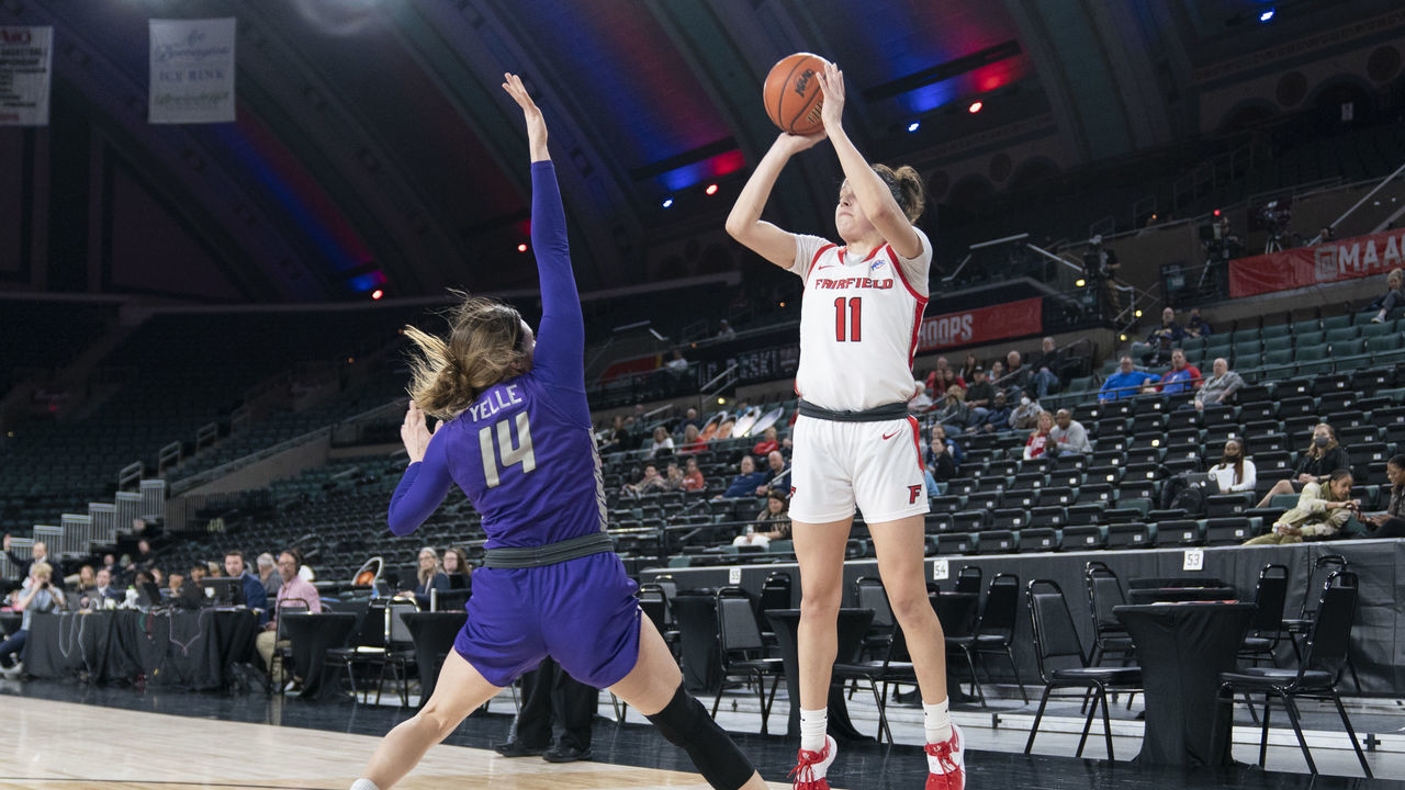 ATLANTIC CITY, NJ - MARCH 11: Fairfield Stags Forward Lou Lopez-Senechal (11) shoots a three point jump shot over Niagara Purple Eagles Guard Maddy Yelle (14) defending during the first half of the MAAC Womens Conference Basketball Tournament quarterfinal game between the Niagara Purple Eagles and the Fairfield Stags on March 11, 2022 at the Boardwalk Hall in Atlantic City, NJ.