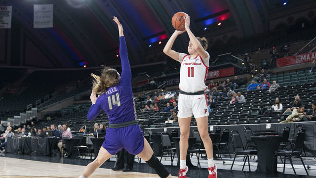 ATLANTIC CITY, NJ - MARCH 11: Fairfield Stags Forward Lou Lopez-Senechal (11) shoots a three point jump shot over Niagara Purple Eagles Guard Maddy Yelle (14) defending during the first half of the MAAC Womens Conference Basketball Tournament quarterfinal game between the Niagara Purple Eagles and the Fairfield Stags on March 11, 2022 at the Boardwalk Hall in Atlantic City, NJ.