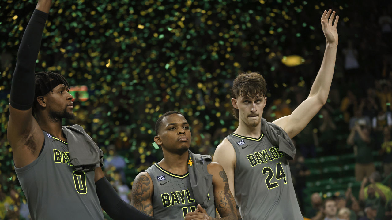WACO, TX - MARCH 5: Flo Thamba #0 along with teammates James Akinjo #11 and Matthew Mayer #24 of the Baylor Bears celebrate team"u2019s 75-68 win over the Iowa State Cyclones at the Ferrell Center on March 5, 2022 in Waco, Texas. Baylor won a share of the Big 12 Championship with the win.