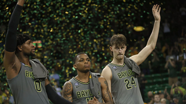 WACO, TX - MARCH 5: Flo Thamba #0 along with teammates James Akinjo #11 and Matthew Mayer #24 of the Baylor Bears celebrate team"u2019s 75-68 win over the Iowa State Cyclones at the Ferrell Center on March 5, 2022 in Waco, Texas. Baylor won a share of the Big 12 Championship with the win.