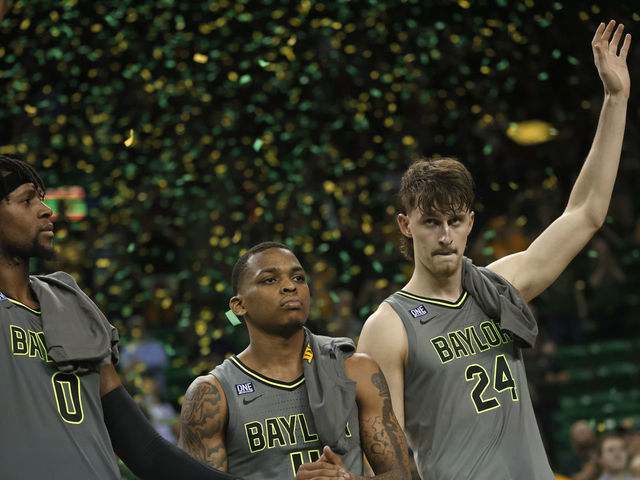 WACO, TX - MARCH 5: Flo Thamba #0 along with teammates James Akinjo #11 and Matthew Mayer #24 of the Baylor Bears celebrate team"u2019s 75-68 win over the Iowa State Cyclones at the Ferrell Center on March 5, 2022 in Waco, Texas. Baylor won a share of the Big 12 Championship with the win.