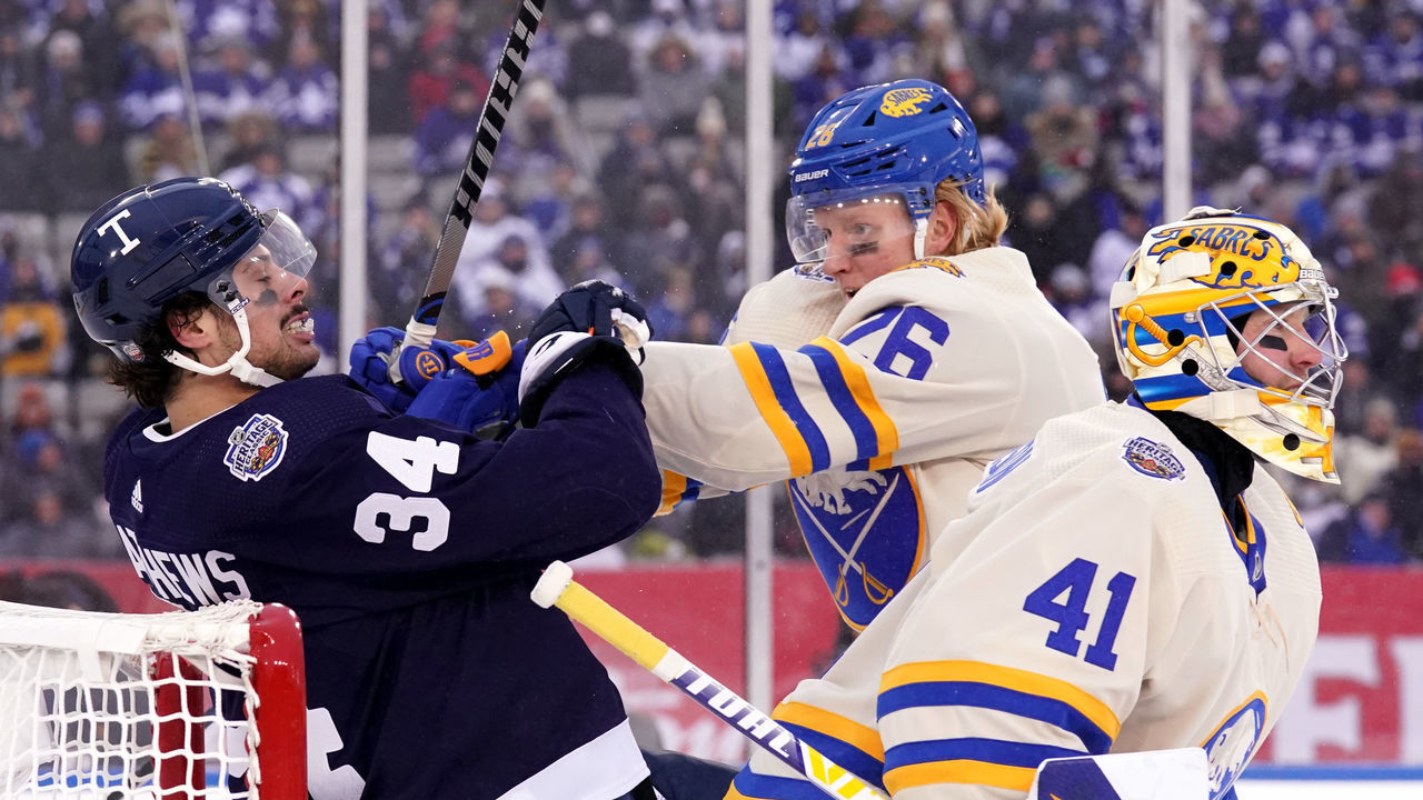 HAMILTON, ONTARIO - MARCH 13: Rasmus Dahlin #26 of the Buffalo Sabres pushes Auston Matthews #34 of the Toronto Maple Leafs during the third period of the 2022 Tim Hortons NHL Heritage Classic between the Toronto Maple Leafs and the Buffalo Sabres at Tim Hortons Field on March 13, 2022 in Hamilton, Ontario.