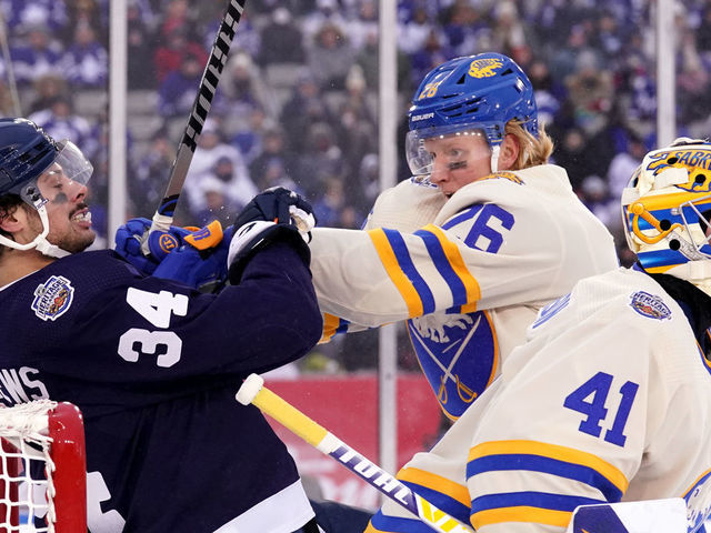 HAMILTON, ONTARIO - MARCH 13: Rasmus Dahlin #26 of the Buffalo Sabres pushes Auston Matthews #34 of the Toronto Maple Leafs during the third period of the 2022 Tim Hortons NHL Heritage Classic between the Toronto Maple Leafs and the Buffalo Sabres at Tim Hortons Field on March 13, 2022 in Hamilton, Ontario.