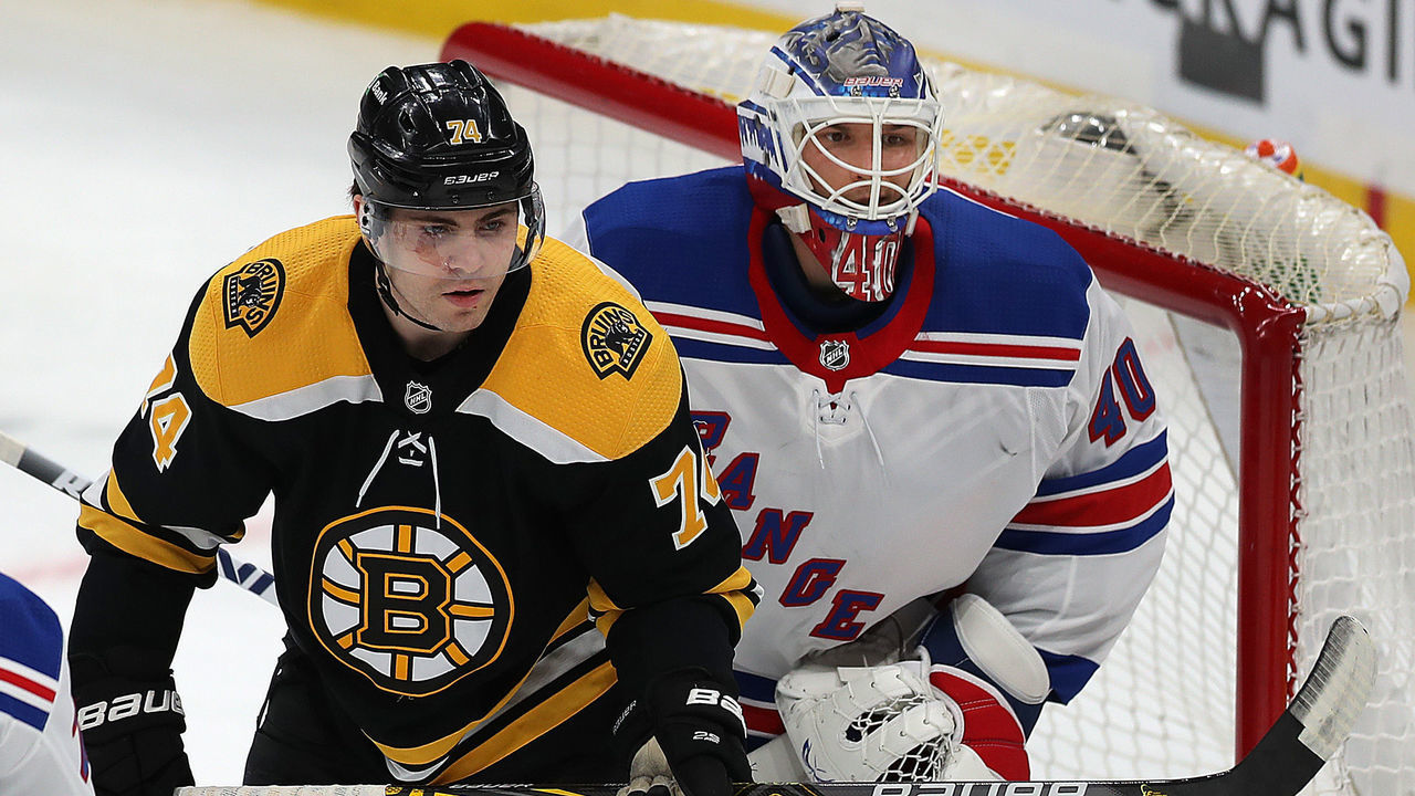Boston - March 11: Boston Bruins vs NY Rangers on March 11, 2021. Boston Bruins left wing Jake DeBrusk (74) stands in front of Rangers goalie Alexandar Georgiev as he holds his new stick.