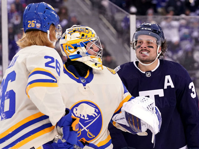 HAMILTON, ONTARIO - MARCH 13: Goaltender Craig Anderson #41 of the Buffalo Sabres gets between Rasmus Dahlin #26 of the Buffalo Sabres and Auston Matthews #34 of the Toronto Maple Leafs after the play was whistled dead during the third period of the 2022 Tim Hortons NHL Heritage Classic between the Toronto Maple Leafs and the Buffalo Sabres at Tim Hortons Field on March 13, 2022 in Hamilton, Ontario.