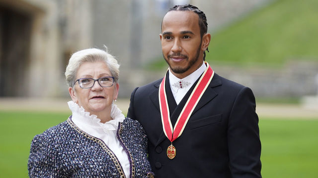 WINDSOR, ENGLAND - DECEMBER 15: Sir Lewis Hamilton with his mother Carmen Lockhart after he was made a Knight Bachelor by the Prince of Wales during a investiture ceremony at Windsor Castle on December 15, 2021 in Windsor, England.