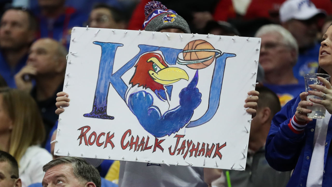 KANSAS CITY, MO - MARCH 12: A Kansas Jayhawks fan holds a Rock Chalk Jayhawk sign in the second half of the Big 12 Tournament championship game between the Texas Tech Red Raiders and Kansas Jayhawks on Mar 12, 2022 at T-Mobile Arena in Kansas City, MO.