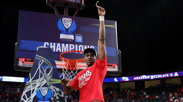 LAS VEGAS, NEVADA - MARCH 12: Christian Koloko #35 of the Arizona Wildcats celebrates after cutting a piece of a basketball net following the team's 84-76 victory over the UCLA Bruins to win the Pac-12 Conference basketball tournament championship game at T-Mobile Arena on March 12, 2022 in Las Vegas, Nevada.