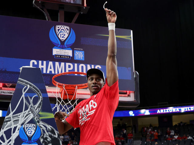 LAS VEGAS, NEVADA - MARCH 12: Christian Koloko #35 of the Arizona Wildcats celebrates after cutting a piece of a basketball net following the team's 84-76 victory over the UCLA Bruins to win the Pac-12 Conference basketball tournament championship game at T-Mobile Arena on March 12, 2022 in Las Vegas, Nevada.