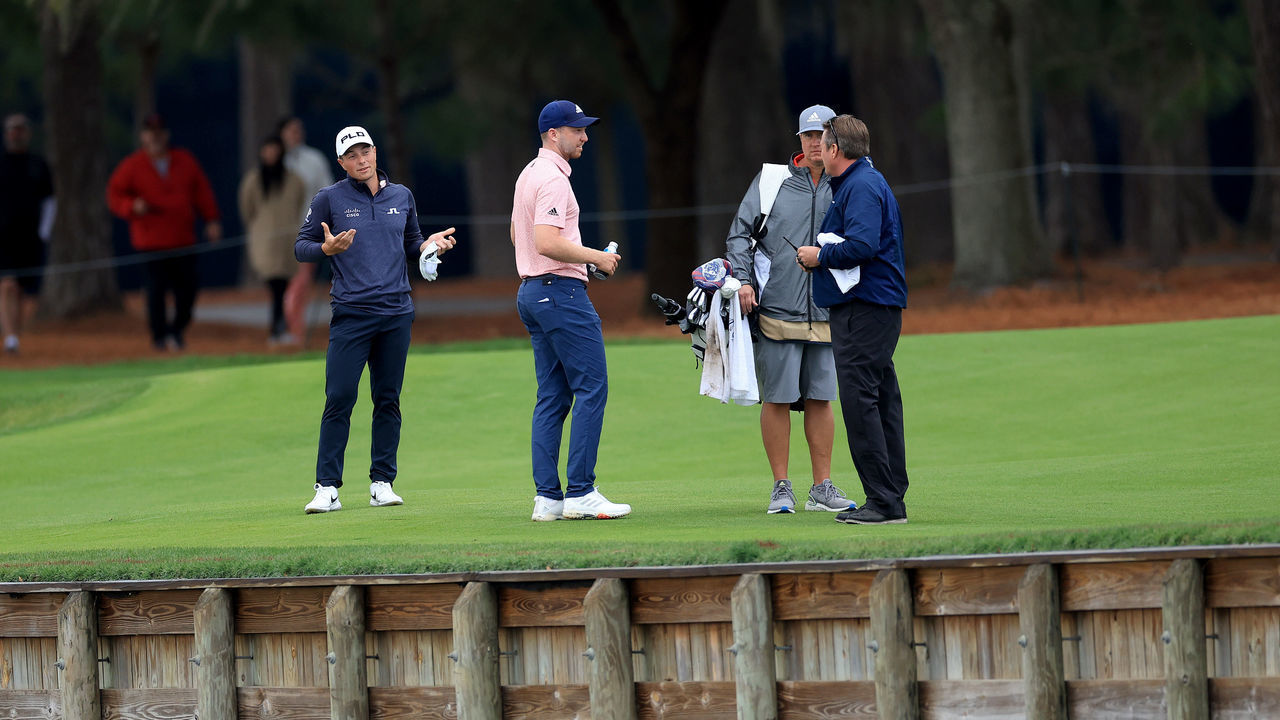 PONTE VEDRA BEACH, FLORIDA - MARCH 14: Viktor Hovland of Norway watches on as his playing partner Daniel Berger debates with Gary Young the PGA Tour rules official as to where his ball had crossed the water hazard for Berger's second shot on the par 5, 16th hole during the final round of THE PLAYERS Championship at TPC Sawgrass on March 14, 2022 in Ponte Vedra Beach, Florida.