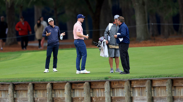 PONTE VEDRA BEACH, FLORIDA - MARCH 14: Viktor Hovland of Norway watches on as his playing partner Daniel Berger debates with Gary Young the PGA Tour rules official as to where his ball had crossed the water hazard for Berger's second shot on the par 5, 16th hole during the final round of THE PLAYERS Championship at TPC Sawgrass on March 14, 2022 in Ponte Vedra Beach, Florida.
