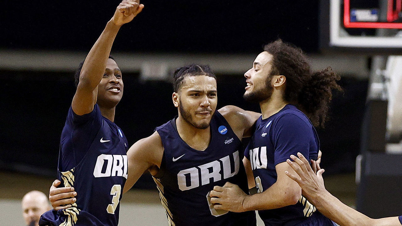 INDIANAPOLIS, INDIANA - MARCH 21: Max Abmas #3, Kevin Obanor #0 and Kareem Thompson #2 of the Oral Roberts Golden Eagles celebrate after defeating the Florida Gators in the second round game of the 2021 NCAA Men's Basketball Tournament at Indiana Farmers Coliseum on March 21, 2021 in Indianapolis, Indiana. Oral Roberts defeated Florida 81-78.