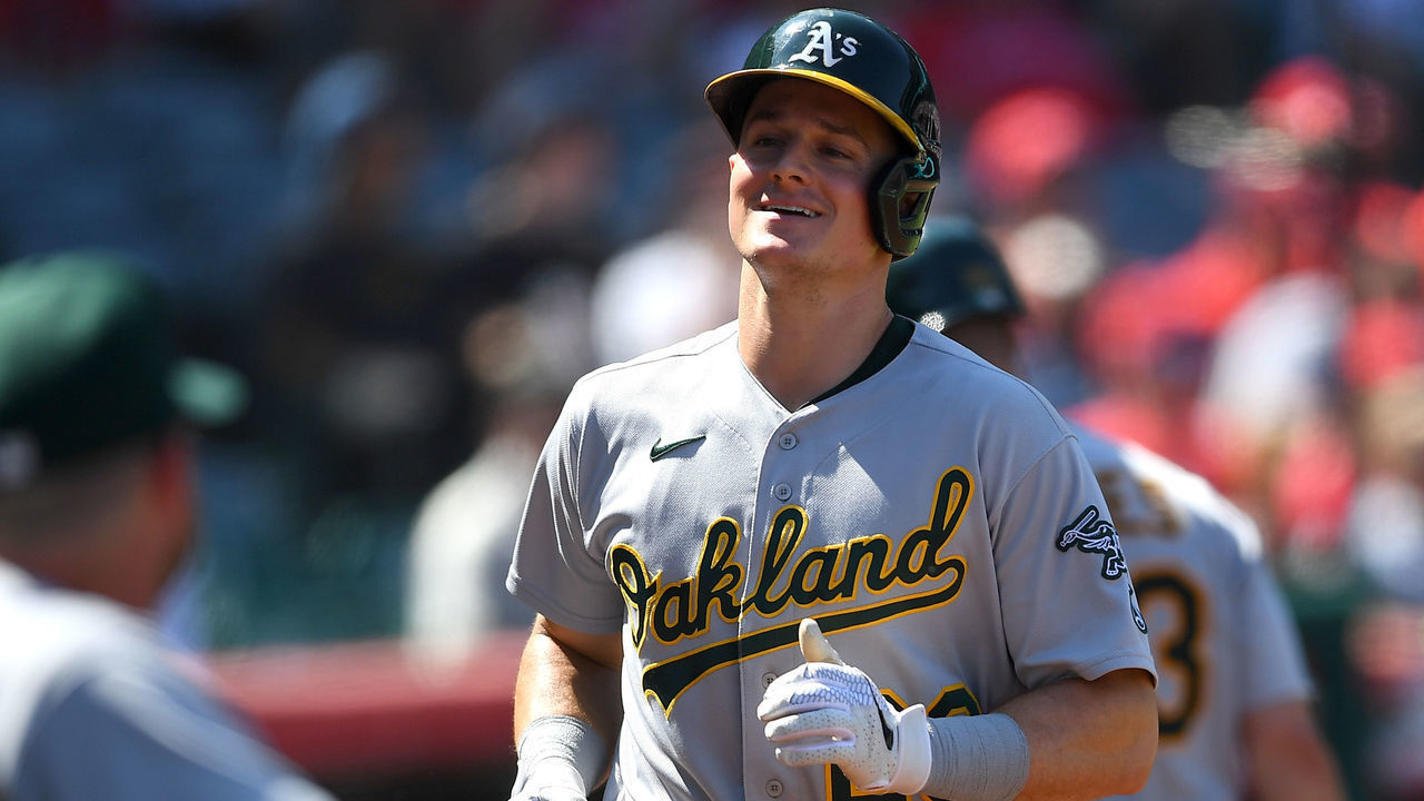 ANAHEIM, CA - SEPTEMBER 19: Matt Chapman #26 of the Oakland Athletics is greeted in the dugout after hitting a solo home run in the fourth inning of the game against the Los Angeles Angels at Angel Stadium of Anaheim on September 19, 2021 in Anaheim, California.