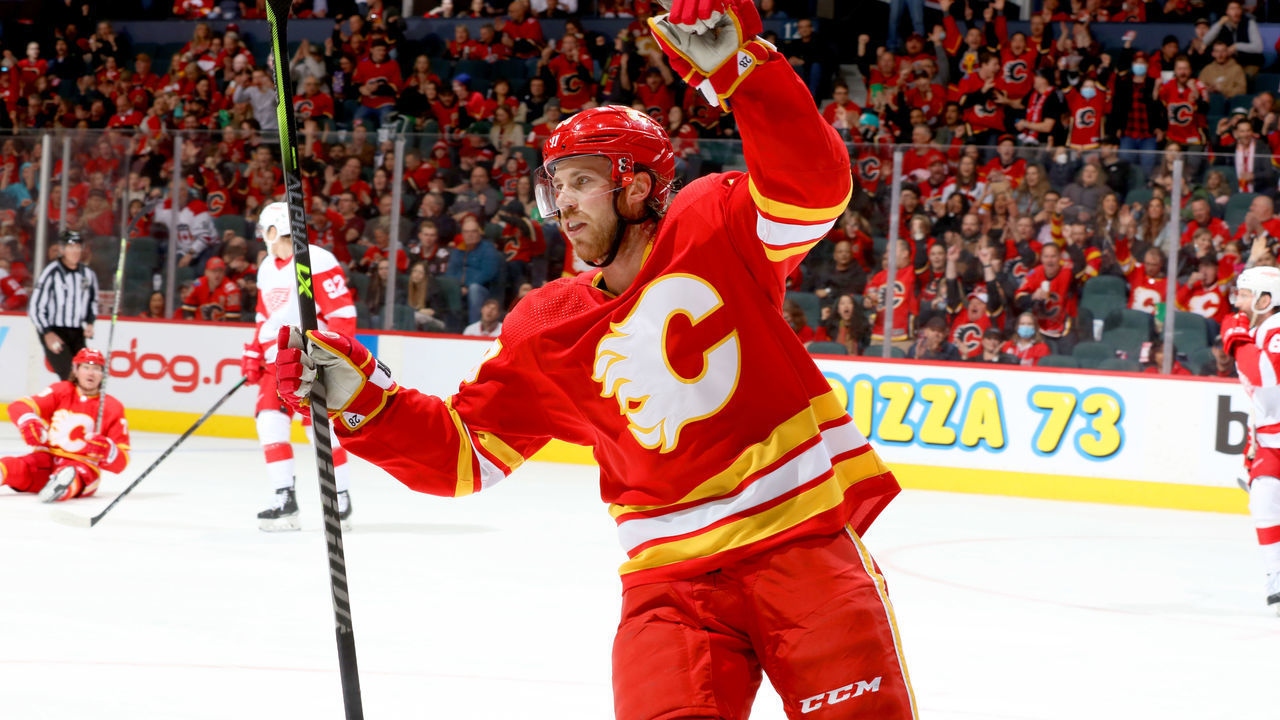 CALGARY, ALBERTA - MARCH 12: Elias Lindholm #28 of the Calgary Flames celebrate a goal against the Detroit Red Wings at Scotiabank Saddledome on March 12, 2022 in Calgary, Alberta.