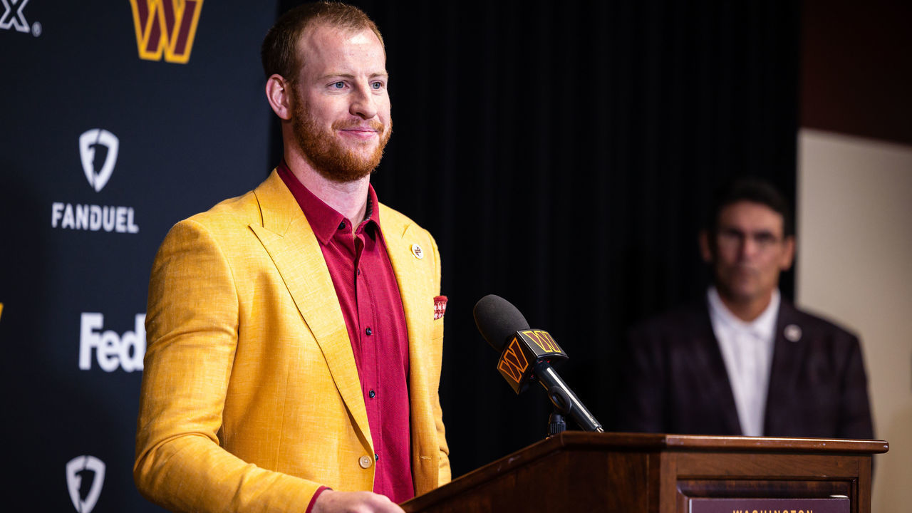 ASHBURN, VA - MARCH 17: Head coach Ron Rivera looks on as quarterback Carson Wentz of the Washington Commanders is introduced at Inova Sports Performance Center on March 17, 2022 in Ashburn, Virginia.