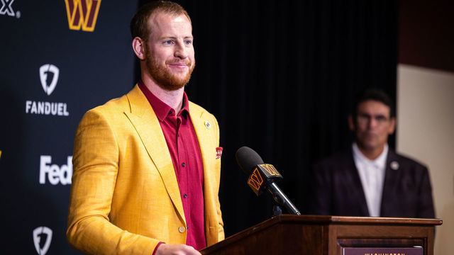 ASHBURN, VA - MARCH 17: Head coach Ron Rivera looks on as quarterback Carson Wentz of the Washington Commanders is introduced at Inova Sports Performance Center on March 17, 2022 in Ashburn, Virginia.