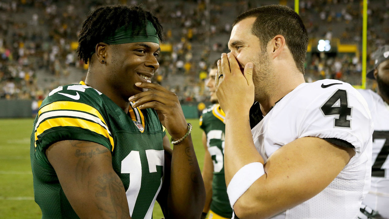 GREEN BAY, WI - AUGUST 18: Davante Adams #17 of the Green Bay Packers and Derek Carr #4 of the Oakland Raiders chat after the preseason game at Lambeau Field on August 18, 2016 in Green Bay, Wisconsin.