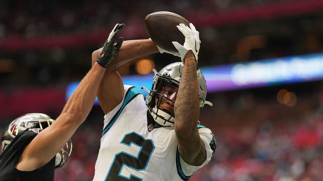 ATLANTA, GEORGIA - OCTOBER 31: DJ Moore #2 of the Carolina Panthers makes a catch while being guarded by Erik Harris #23 of the Atlanta Falcons in the first quarter at Mercedes-Benz Stadium on October 31, 2021 in Atlanta, Georgia.