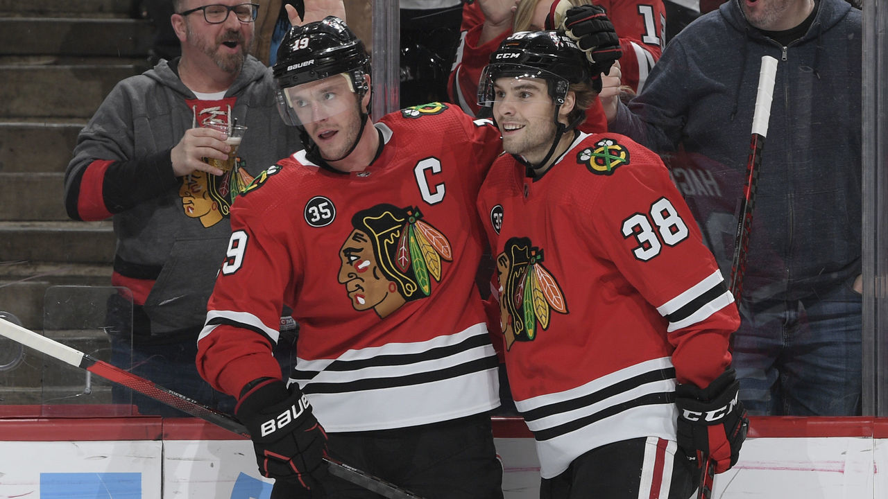CHICAGO, ILLINOIS - MARCH 08: Jonathan Toews #19 and Brandon Hagel #38 of the Chicago Blackhawks celebrate after Toews scored against the Anaheim Ducks in the first period at United Center on March 08, 2022 in Chicago, Illinois.