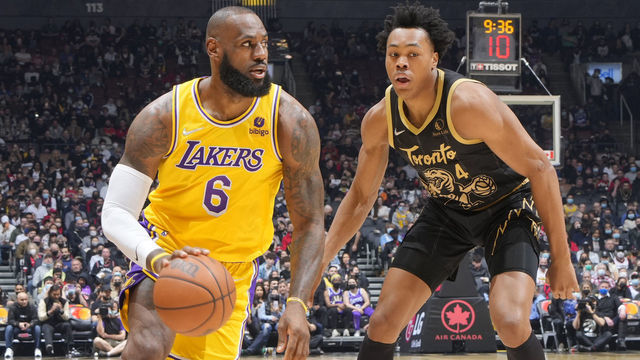 TORONTO, CANADA - MARCH 18: Scottie Barnes #4 of the Toronto Raptors plays defense on LeBron James #6 of the Los Angeles Lakers during the game on March 18, 2022 at the Scotiabank Arena in Toronto, Ontario, Canada. Mandatory Copyright Notice: Copyright 2022 NBAE