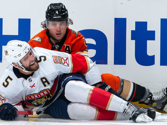 ANAHEIM, CA - MARCH 18: Aaron Ekblad #5 of the Florida Panthers reacts after suffering an injury in a collision with Cam Fowler #4 of the Anaheim Ducks during the first period of the game at Honda Center on March 18, 2022 in Anaheim, California.