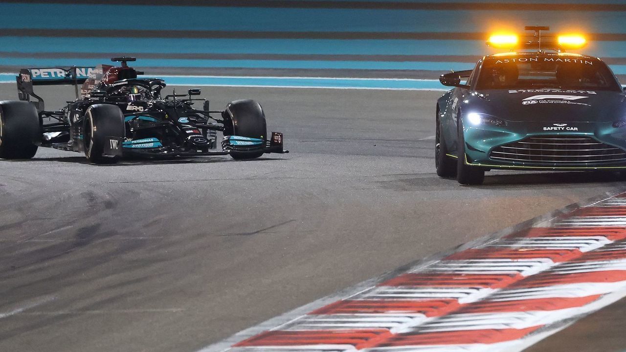 TOPSHOT - Mercedes' British driver Lewis Hamilton drives behind the safety car at the Yas Marina Circuit during the Abu Dhabi Formula One Grand Prix on December 12, 2021.