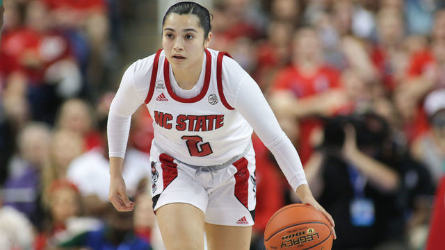 GREENSBORO, NC - MARCH 05: NC State Wolfpack guard Raina Perez (2) brings the ball up court during the ACC Tournament championship game between the North Carolina State Wolfpack and the Miami Hurricanes on March 5, 2022 at Greensboro Coliseum.