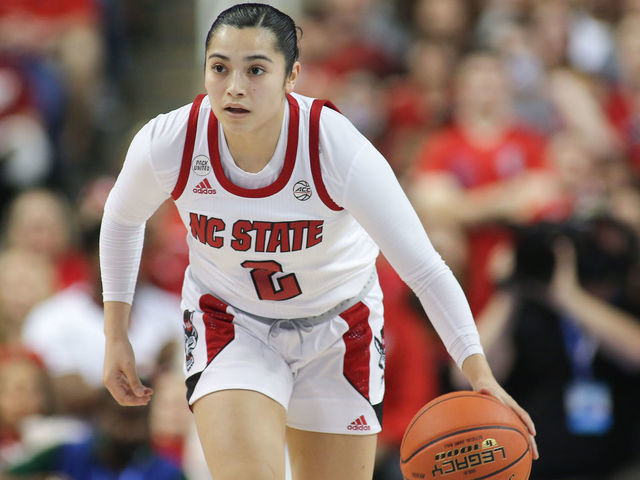 GREENSBORO, NC - MARCH 05: NC State Wolfpack guard Raina Perez (2) brings the ball up court during the ACC Tournament championship game between the North Carolina State Wolfpack and the Miami Hurricanes on March 5, 2022 at Greensboro Coliseum.