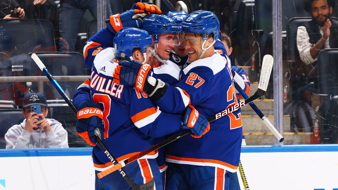 ELMONT, NEW YORK - MARCH 19: Brock Nelson #29 of the New York Islanders celebrates his second period goal with Anthony Beauvillier #18 and Anders Lee #27of the New York Islanders against the Dallas Stars at UBS Arena on March 19, 2022 in Elmont, New York.