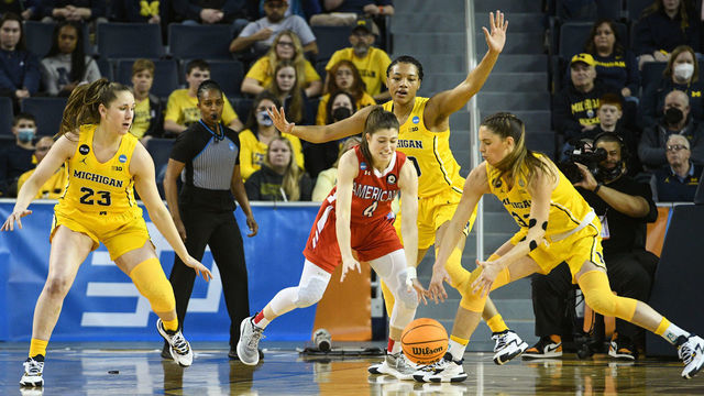 ANN ARBOR, MI - MARCH 19: American Eagles guard Emily Fisher (4) and Michigan Wolverines forward Emily Kiser (33) scramble for a loose ball while Michigan Wolverines guard Danielle Rauch (23) and Michigan Wolverines forward Naz Hillmon (0) look on during a game between the American Eagles and the Michigan Wolverines during the first round of the 2022 NCAA Women's Basketball Tournament held at Crisler Arena on March 19, 2022 in Ann Arbor, Michigan.