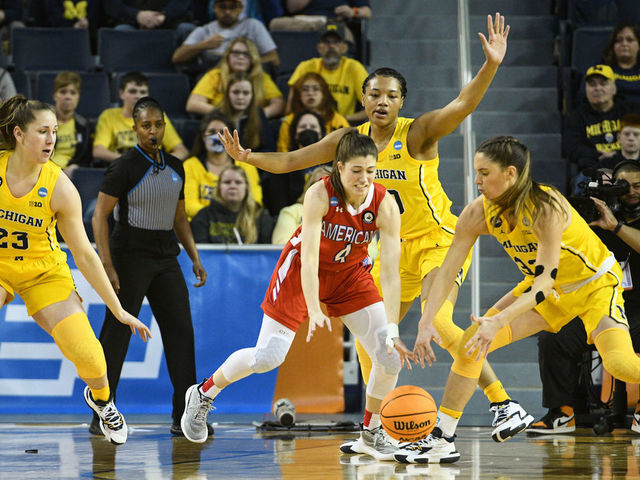 ANN ARBOR, MI - MARCH 19: American Eagles guard Emily Fisher (4) and Michigan Wolverines forward Emily Kiser (33) scramble for a loose ball while Michigan Wolverines guard Danielle Rauch (23) and Michigan Wolverines forward Naz Hillmon (0) look on during a game between the American Eagles and the Michigan Wolverines during the first round of the 2022 NCAA Women's Basketball Tournament held at Crisler Arena on March 19, 2022 in Ann Arbor, Michigan.