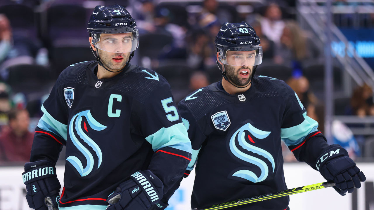 SEATTLE, WASHINGTON - JANUARY 01: Mark Giordano #5 and Colin Blackwell #43 of the Seattle Kraken react during the third period against the Vancouver Canucks at Climate Pledge Arena on January 01, 2022 in Seattle, Washington.
