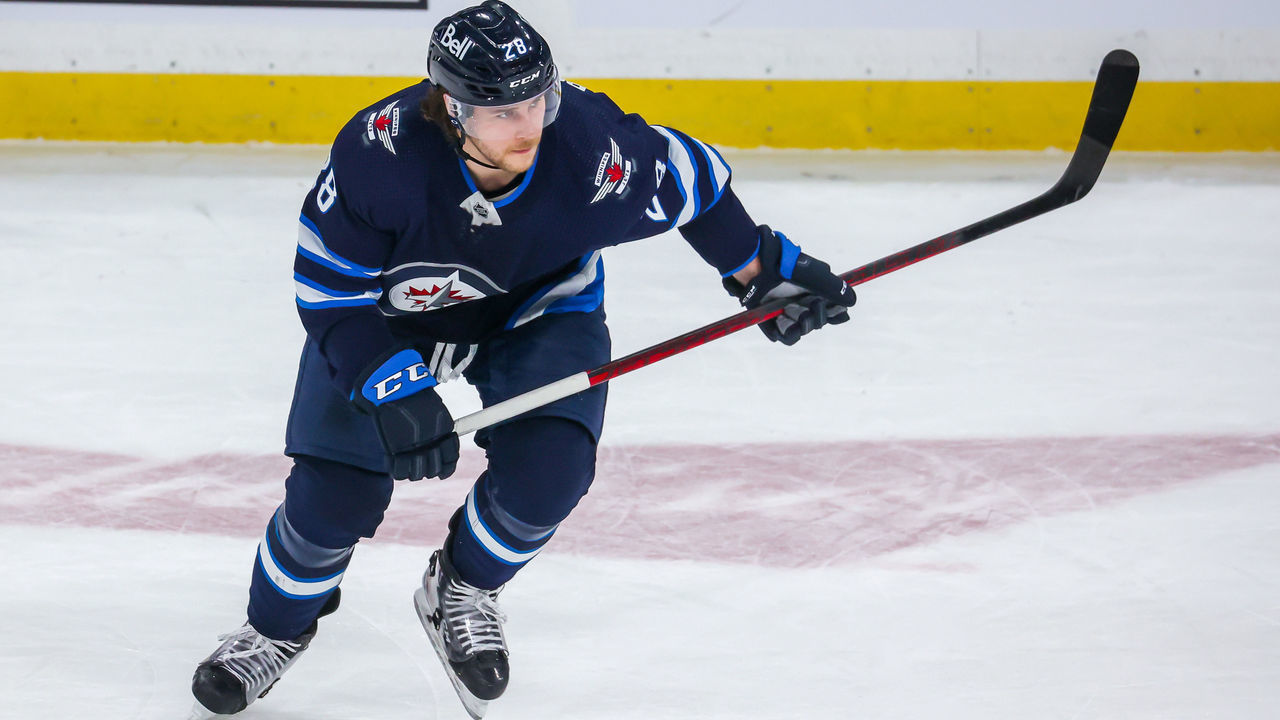 WINNIPEG, MB - JANUARY 27: Nathan Beaulieu #28 of the Winnipeg Jets keeps an eye on the play during second period action against the Vancouver Canucks at Canada Life Centre on January 27, 2022 in Winnipeg, Manitoba, Canada.