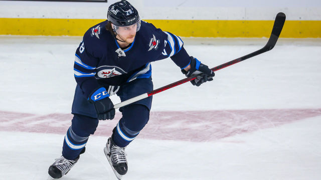 WINNIPEG, MB - JANUARY 27: Nathan Beaulieu #28 of the Winnipeg Jets keeps an eye on the play during second period action against the Vancouver Canucks at Canada Life Centre on January 27, 2022 in Winnipeg, Manitoba, Canada.