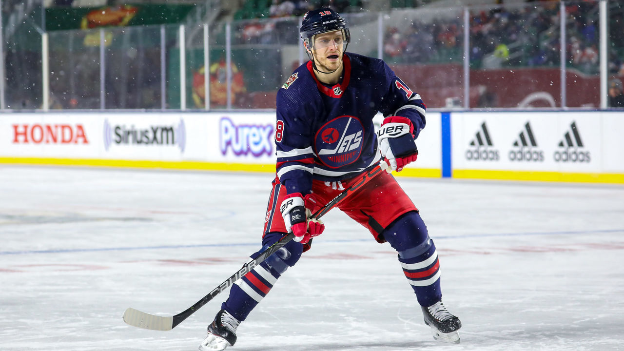 REGINA, SK - OCTOBER 26: Bryan Little #18 of the Winnipeg Jets keeps an eye on the play during third period action against the Calgary Flames during the 2019 Tim Hortons NHL Heritage Classic at Mosaic Stadium on October 26, 2019 in Regina, Saskatchewan, Canada. The Jets defeated the Flames 2-1 in overtime.