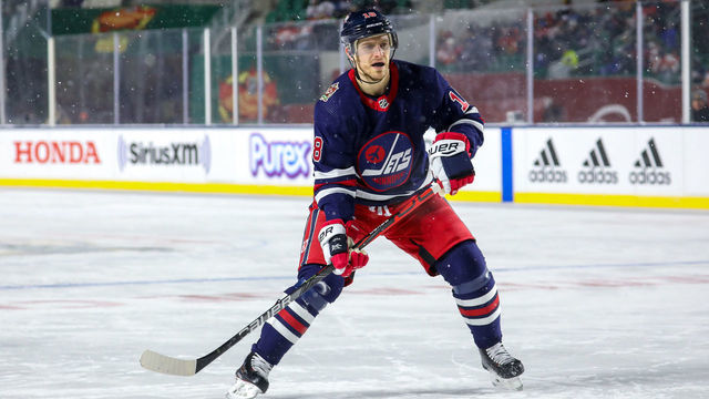 REGINA, SK - OCTOBER 26: Bryan Little #18 of the Winnipeg Jets keeps an eye on the play during third period action against the Calgary Flames during the 2019 Tim Hortons NHL Heritage Classic at Mosaic Stadium on October 26, 2019 in Regina, Saskatchewan, Canada. The Jets defeated the Flames 2-1 in overtime.