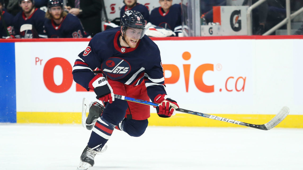 WINNIPEG, MB - DECEMBER 17: Winnipeg Jets forward Andrew Copp (9) skates after the puck during the regular season game between the Winnipeg Jets and the Washington Capitals on December 17, 2021 at the Canada Life Centre in Winnipeg MB.